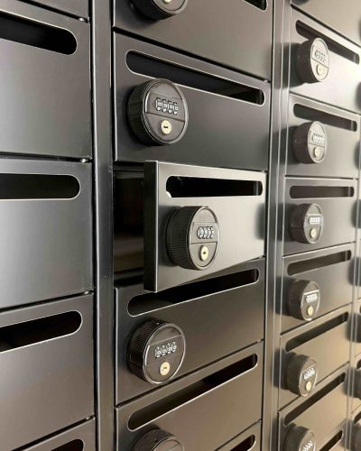 Geöffnetes Fach einer modernen schwarzen Briefkastenanlage mit Zahlenschloss im Smarvo-Gebäude.